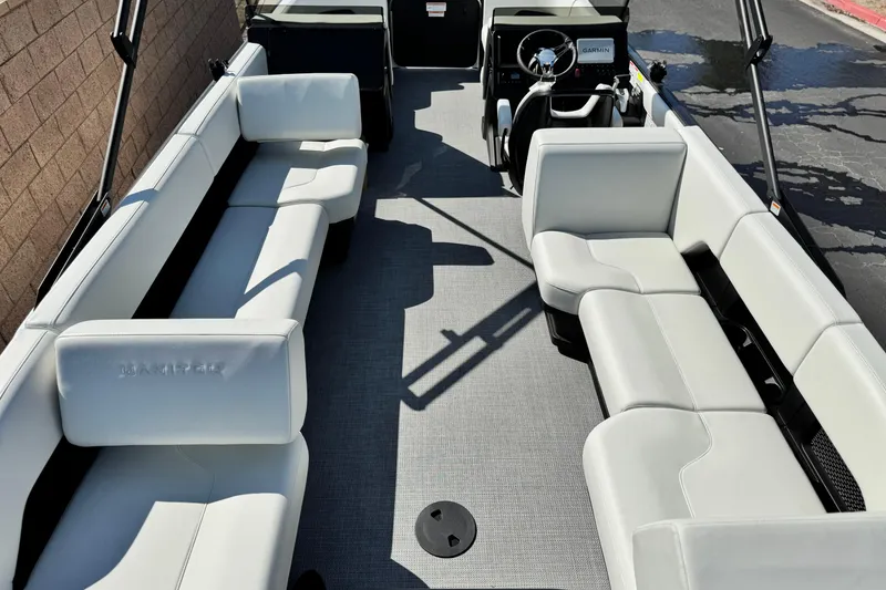 Slide: The Image of 2026 Manitou Cruise 22 Max pontoon boat interior with white seating and modern dashboard. - 20