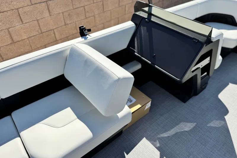 Slide: The Image of 2026 Manitou Cruise 22 Max interior with white seating and modern dashboard. - 21