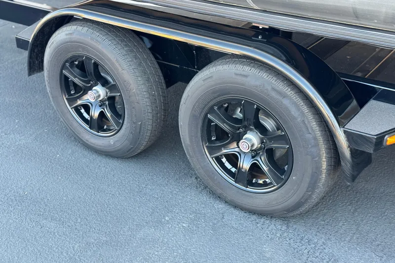 Slide: The Image of 2026 Manitou Cruise 22 Max trailer with black alloy wheels on asphalt. - 25