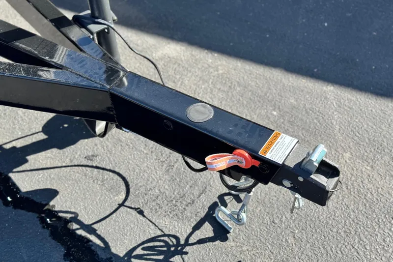 Slide: The Image of Trailer hitch of 2026 Manitou Cruise 22 Max on asphalt surface. - 26