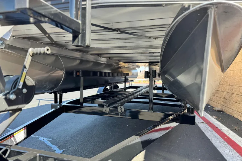 Slide: The Image of Underneath view of 2026 Manitou Cruise 22 Max pontoon boat on trailer. - 4