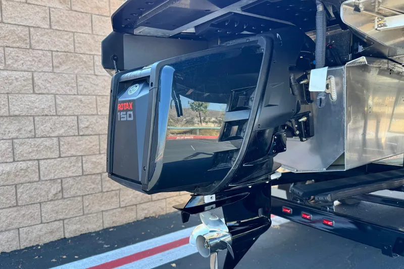 Slide: The Image of 2026 Manitou Cruise 22 Max with Rotax 150 engine, close-up view. - 7