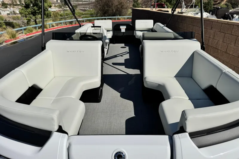 Slide: The Image of 2026 Manitou Cruise 22 Max pontoon boat with spacious white seating and modern design. - 8