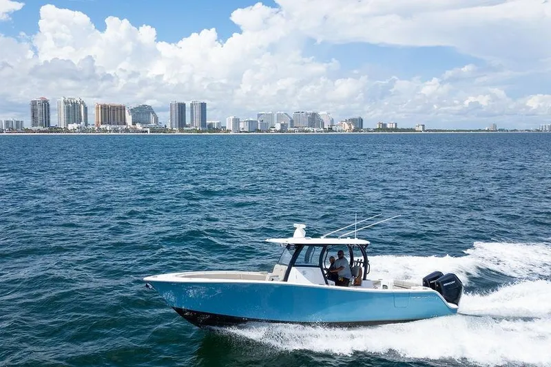 Slide: The Image of 2023 Sportsman Open 322 Center Console boat cruising near city skyline. - 10