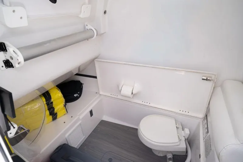 Slide: The Image of 2023 Sportsman Open 322 Center Console interior with toilet and storage area. - 23