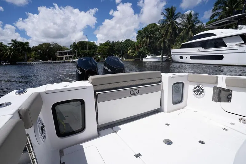 Slide: The Image of 2023 Sportsman Open 322 Center Console boat on a sunny day by the water. - 24