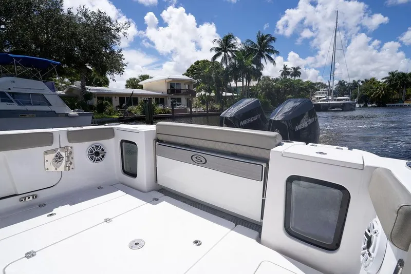 Slide: The Image of 2023 Sportsman Open 322 Center Console boat on a sunny waterfront. - 25
