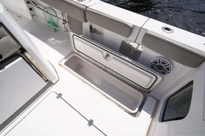 Slide: The Image of 2023 Sportsman Open 322 Center Console boat interior with open storage compartment. - 26