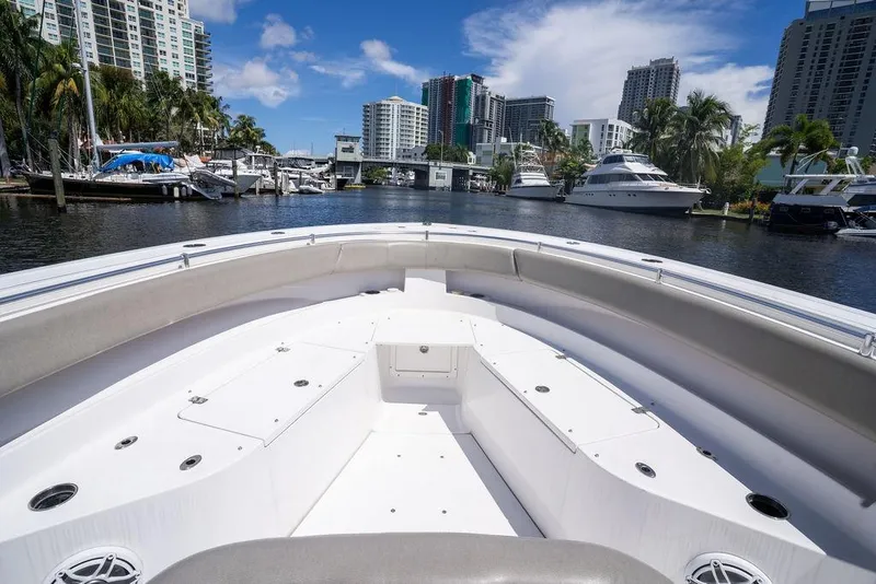 Slide: The Image of 2023 Sportsman Open 322 Center Console boat in a marina with city skyline. - 29