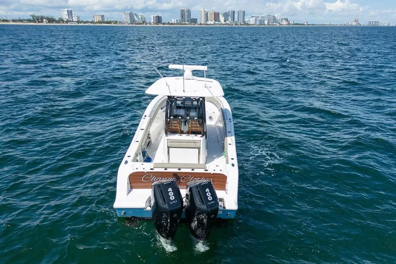 Slide: The Image of 2023 Sportsman Open 322 Center Console boat on ocean, city skyline in background. - 3