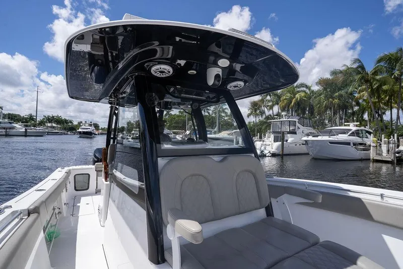 Slide: The Image of 2023 Sportsman Open 322 Center Console boat docked, featuring sleek design and spacious seating. - 30