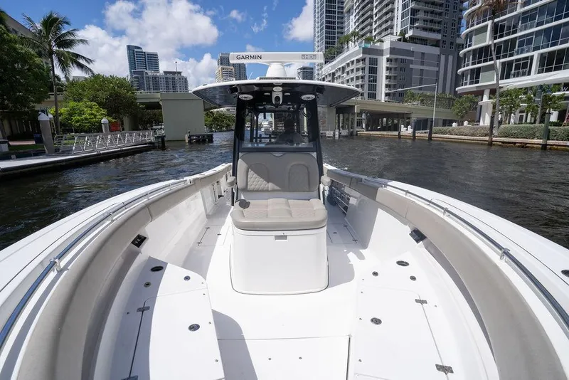 Slide: The Image of 2023 Sportsman Open 322 Center Console boat on a sunny waterfront. - 31