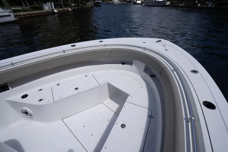 Slide: The Image of 2023 Sportsman Open 322 Center Console boat, spacious deck view, docked on calm water. - 33