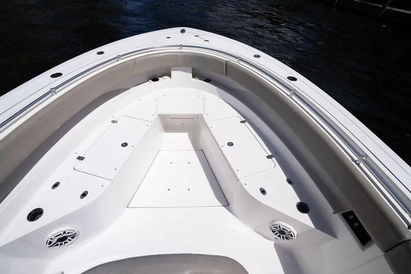 Slide: The Image of 2023 Sportsman Open 322 Center Console boat deck with seating and storage compartments. - 34