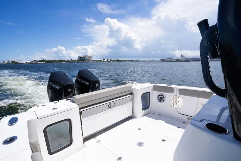 Slide: The Image of 2023 Sportsman Open 322 Center Console boat on water, featuring dual Mercury engines. - 35