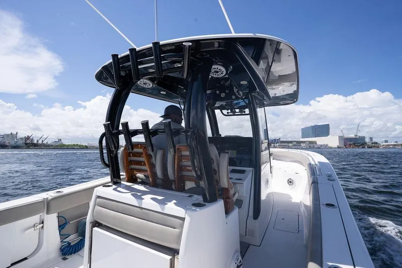 Slide: The Image of 2023 Sportsman Open 322 Center Console boat cruising on a sunny day. - 36