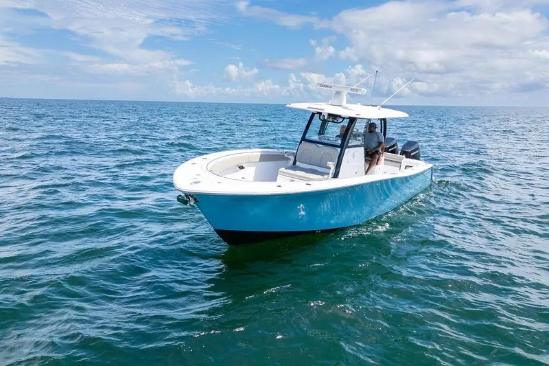 Slide: The Image of 2023 Sportsman Open 322 Center Console boat on open sea under blue sky. - 4