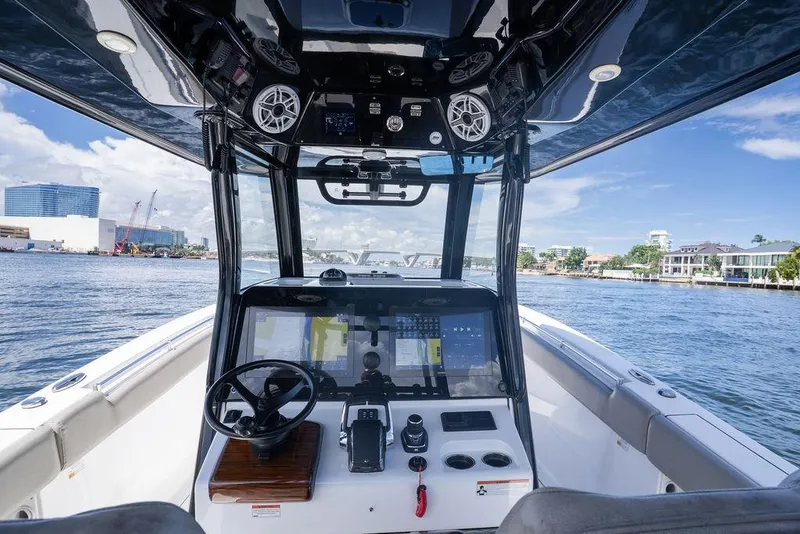 Slide: The Image of 2023 Sportsman Open 322 Center Console boat interior with advanced navigation system on a sunny day. - 41