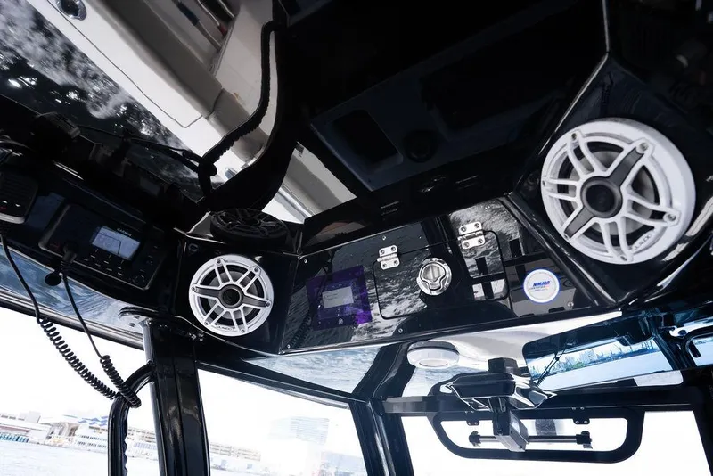 Slide: The Image of 2023 Sportsman Open 322 Center Console boat interior with speakers and control panel. - 44