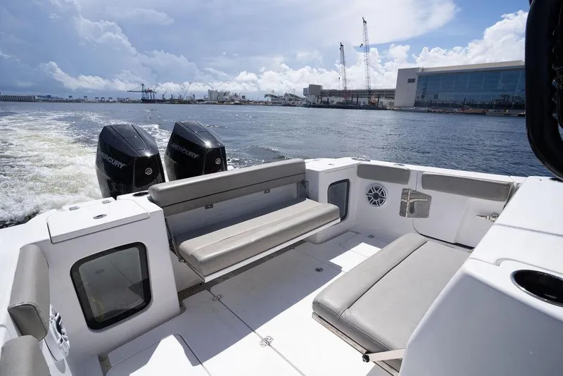 Slide: The Image of 2023 Sportsman Open 322 Center Console boat with dual Mercury engines on open water. - 48