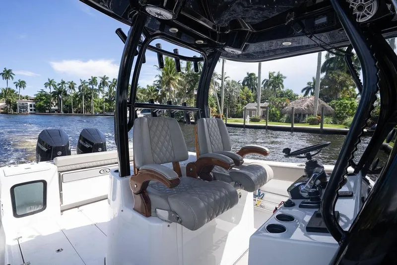 Slide: The Image of 2023 Sportsman Open 322 Center Console boat interior with luxurious seating and dual engines. - 51