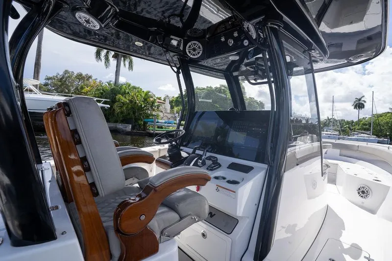 Slide: The Image of 2023 Sportsman Open 322 Center Console boat interior with helm and seating. - 52