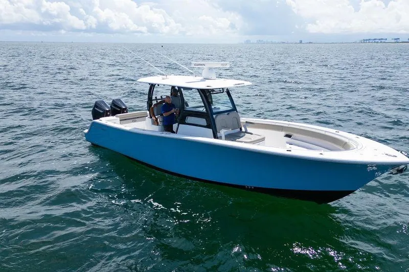 Slide: The Image of 2023 Sportsman Open 322 Center Console boat on open water under cloudy sky. - 6