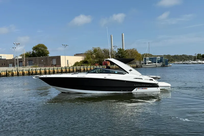 The Image of 2018 Monterey 328SS Super Sport boat cruising in a marina under a clear sky. - 0