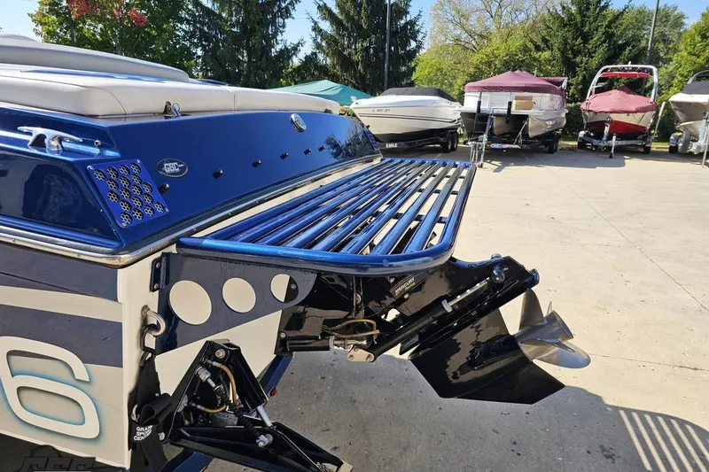 Slide: The Image of 2010 Hustler 266 Classic boat with blue detailing and powerful outboard motor. - 27