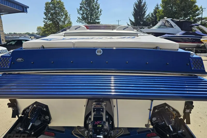 Slide: The Image of 2010 Hustler 266 Classic boat, blue exterior, rear view with dual engines. - 29