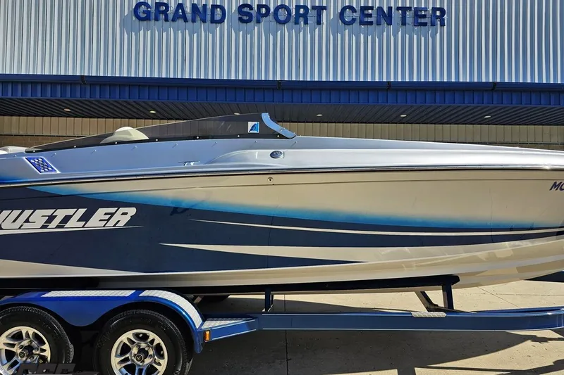 Slide: The Image of 2010 Hustler 266 Classic boat at Grand Sport Center, side view. - 3