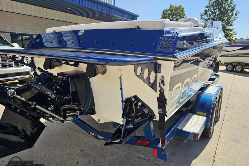 Slide: The Image of 2010 Hustler 266 Classic boat on trailer, featuring a powerful Mercury engine. - 30