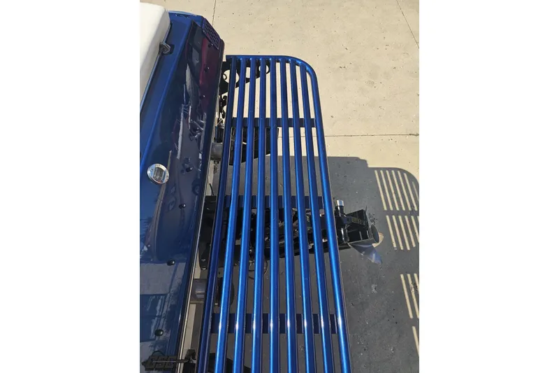 Slide: The Image of 2010 Hustler 266 Classic boat with blue metal railing and propeller. - 32