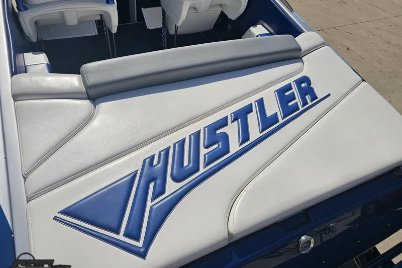 Slide: The Image of 2010 Hustler 266 Classic boat interior with blue and white upholstery design. - 33