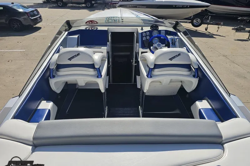 Slide: The Image of 2010 Hustler 266 Classic boat interior with white and blue seating. - 34