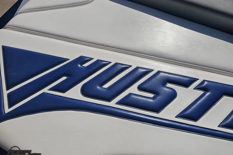 Slide: The Image of Blue and white upholstery with "Hustler" logo on 2010 Hustler 266 Classic boat. - 36