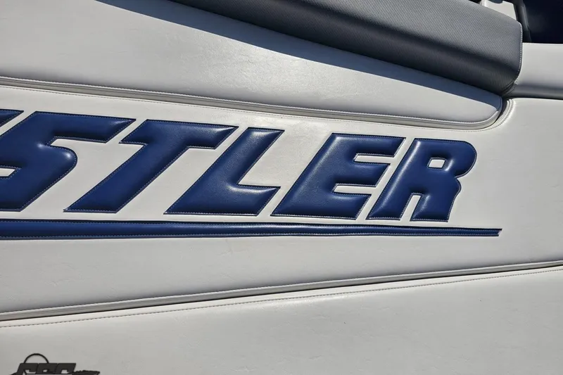 Slide: The Image of Blue "Hustler" logo on white upholstery, 2010 Hustler 266 Classic boat. - 37