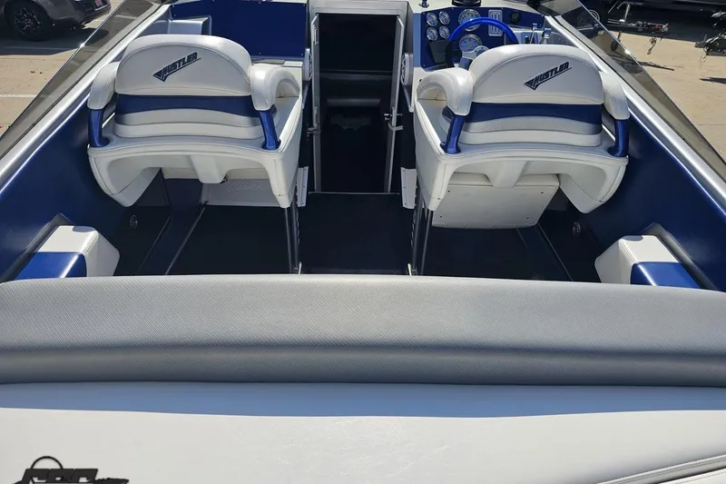 Slide: The Image of 2010 Hustler 266 Classic boat interior with white and blue seating. - 38