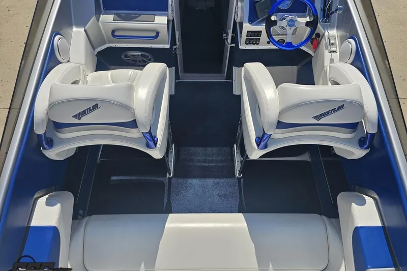 Slide: The Image of Interior of a 2010 Hustler 266 Classic boat with white and blue seating. - 42