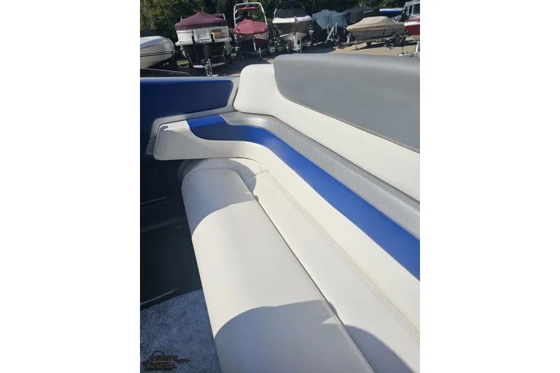 Slide: The Image of 2010 Hustler 266 Classic boat interior with white and blue seating. - 43