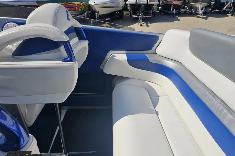 Slide: The Image of Interior of a 2010 Hustler 266 Classic boat with blue and white seating. - 44