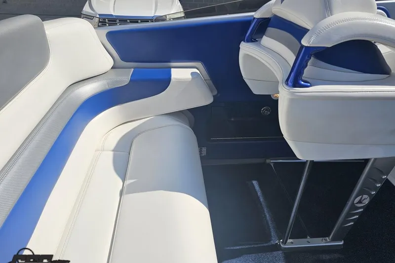 Slide: The Image of 2010 Hustler 266 Classic boat interior with blue and white seating. - 46