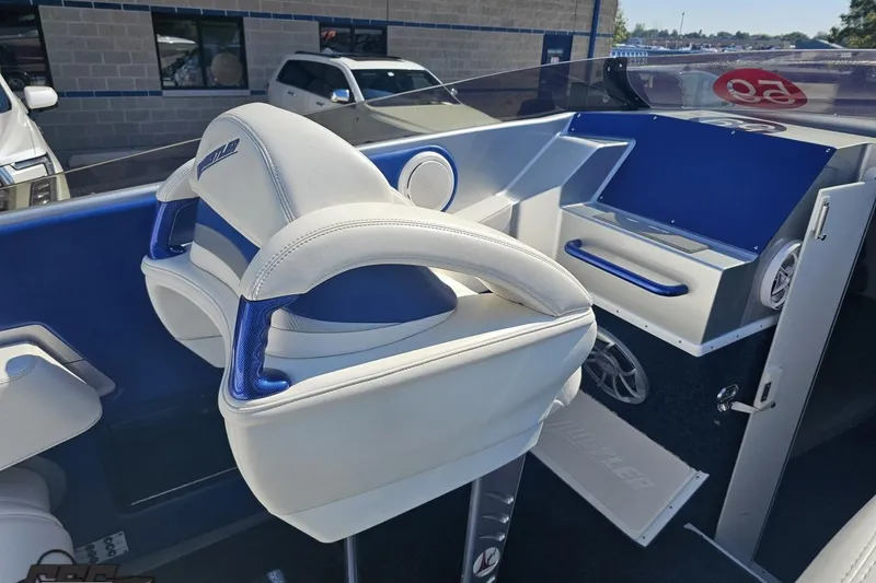 Slide: The Image of Interior of a 2010 Hustler 266 Classic boat with blue and white seating. - 47