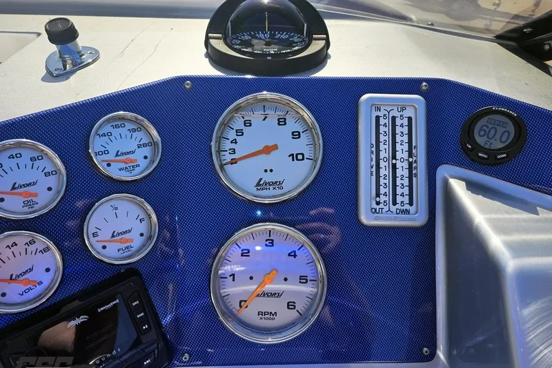 Slide: The Image of Dashboard of a 2010 Hustler 266 Classic boat with gauges and controls. - 59