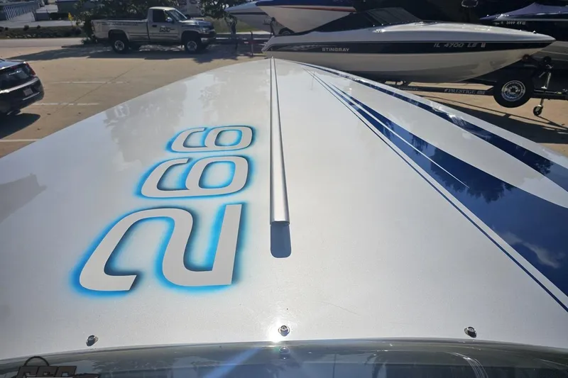 Slide: The Image of 2010 Hustler 266 Classic boat with blue and white graphics on deck. - 60