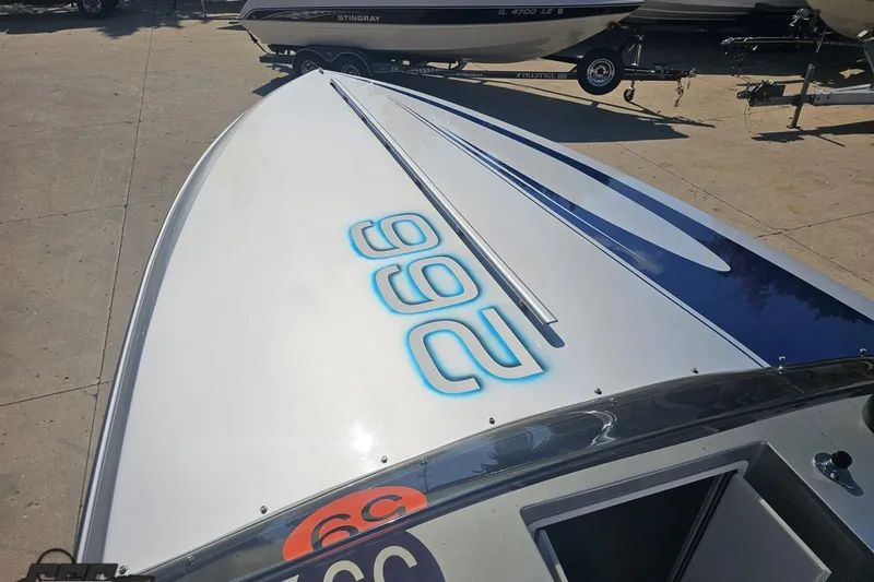 Slide: The Image of 2010 Hustler 266 Classic boat with sleek design and bold "266" graphics. - 61