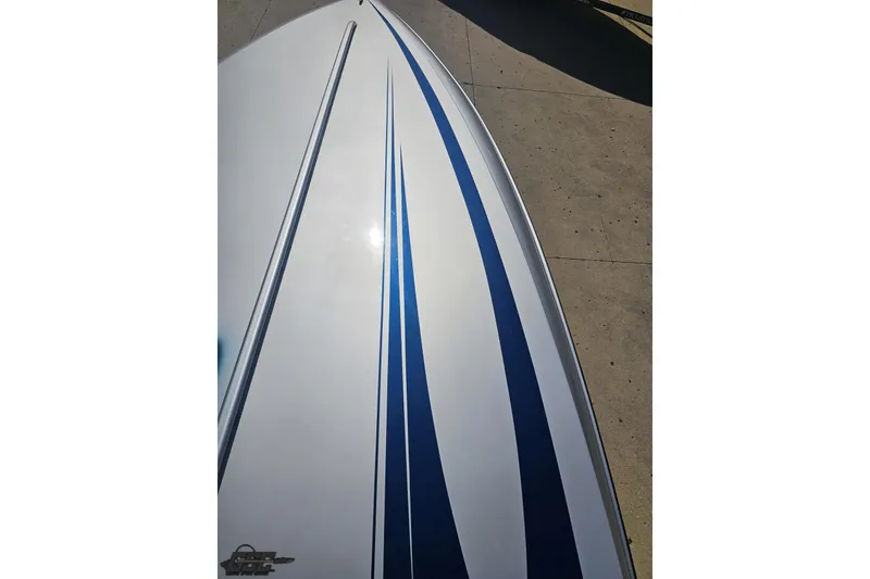 Slide: The Image of 2010 Hustler 266 Classic boat with sleek blue and white design on deck. - 63