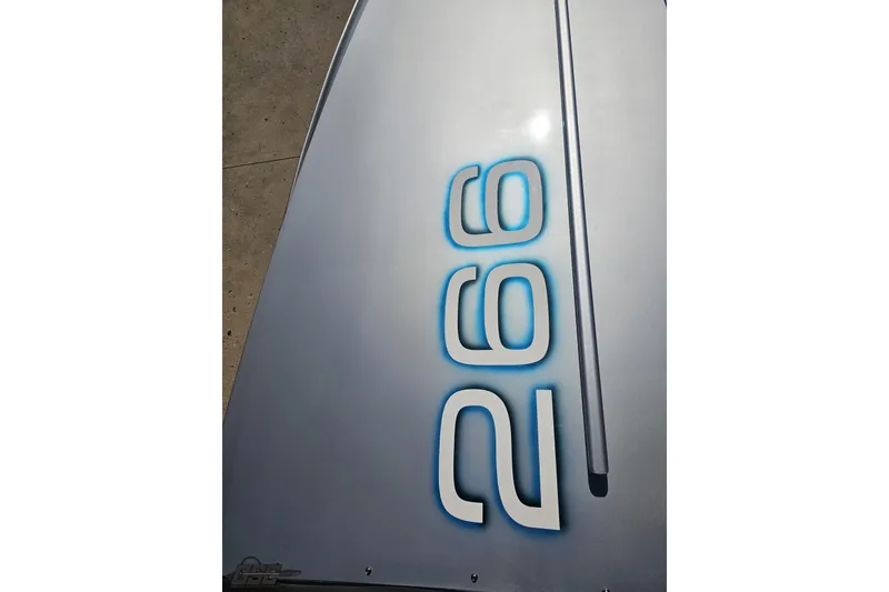 Slide: The Image of Close-up of 2010 Hustler 266 Classic boat model number on sleek surface. - 64