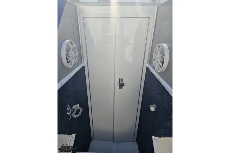 Slide: The Image of 2010 Hustler 266 Classic boat interior with speakers and storage compartment. - 66