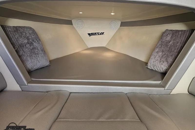 Slide: The Image of Interior cabin of 2010 Hustler 266 Classic boat with cushions and ambient lighting. - 69